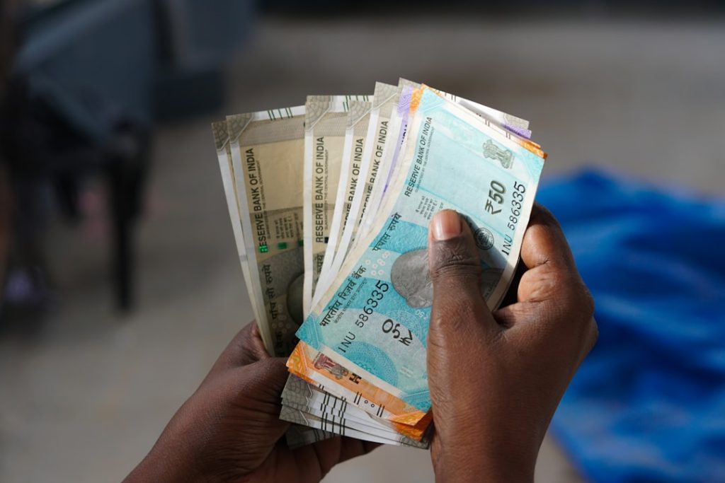 a-person-holding-a-bunch-of-money-in-their-hand-slromnrewsk a-person-holding-a-bunch-of-money-in-their-hand-slromnrewsk